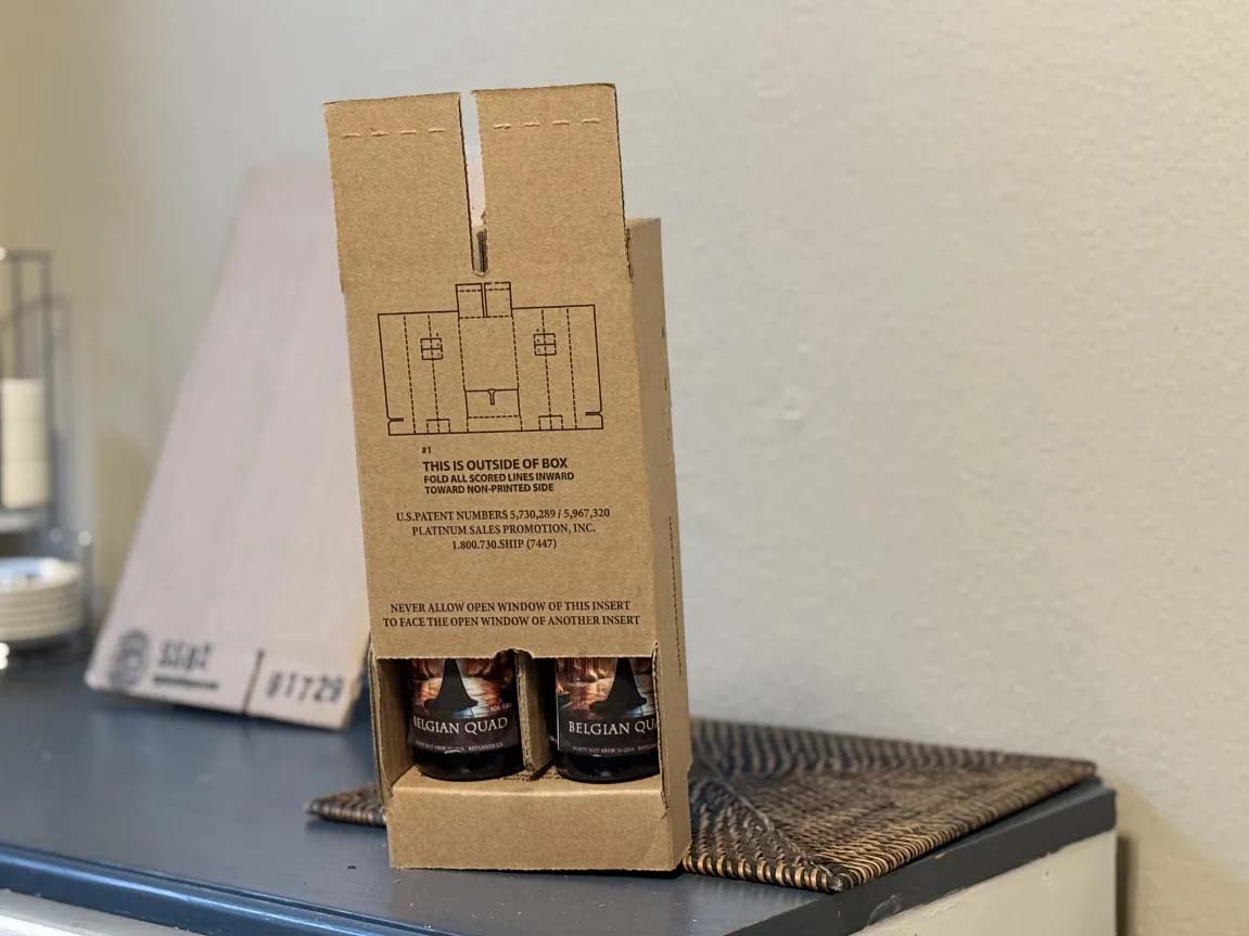 Inserting bottles into folded box